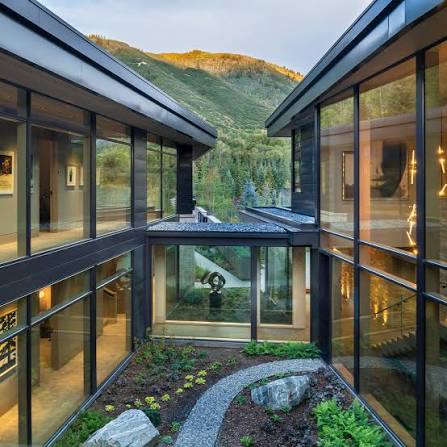 Glass-walled courtyard with mountain views